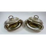 A pair of silver plated oval entree dishes by M H & Co