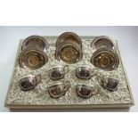 A presentation set of six silver plated ceramic lined coffee cups and saucers, boxed