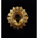 A 9 carat gold ring set oval cut citrine within gold petal form surround, size M, 4.1g