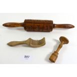 A Victorian wooden biscuit mould rolling pin, a butter curler and a butter stamp