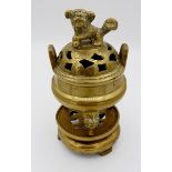 A small 20th century Chinese brass incense burner on stand with Fo dog finial to lid and masks to