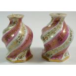 A pair of early 19th century porcelain scent bottles of spiral fluted form with pink banding, 12cm