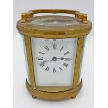 An Edwardian brass oval carriage clock, 11.5cm to top of case