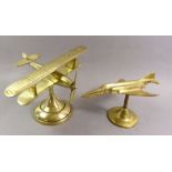 Two brass model aeroplanes on stands