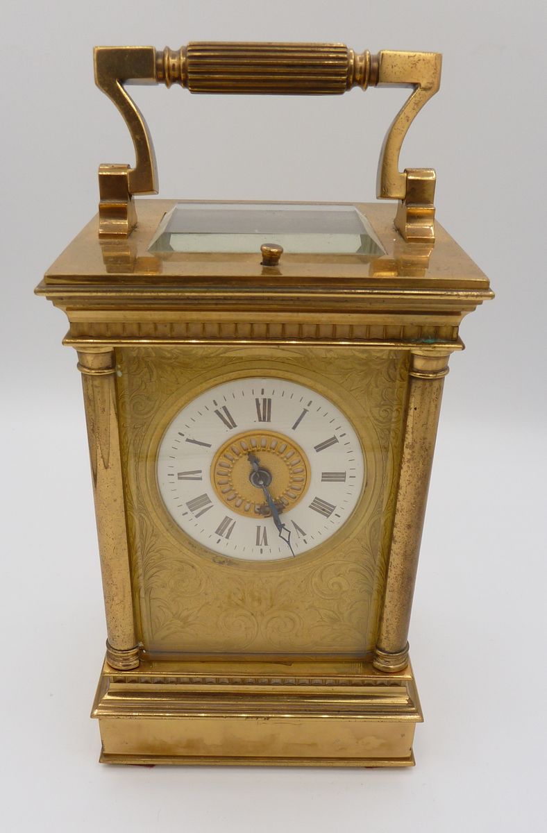 A Victorian brass carriage clock with four columns and repeater striking movement, 16cm to top of