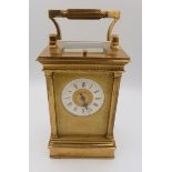 A Victorian brass carriage clock with four columns and repeater striking movement, 16cm to top of