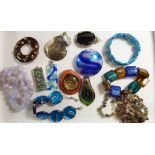 A group of glass pendants, two stone bracelets, a stone necklace etc.