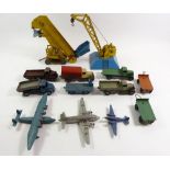 A box of mainly pre-1950's Dinky trucks, platform crane and three aeroplanes