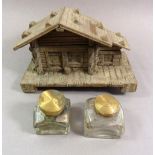 Two 19th century cut glass inkwells and a novelty chalet wooden inkwell