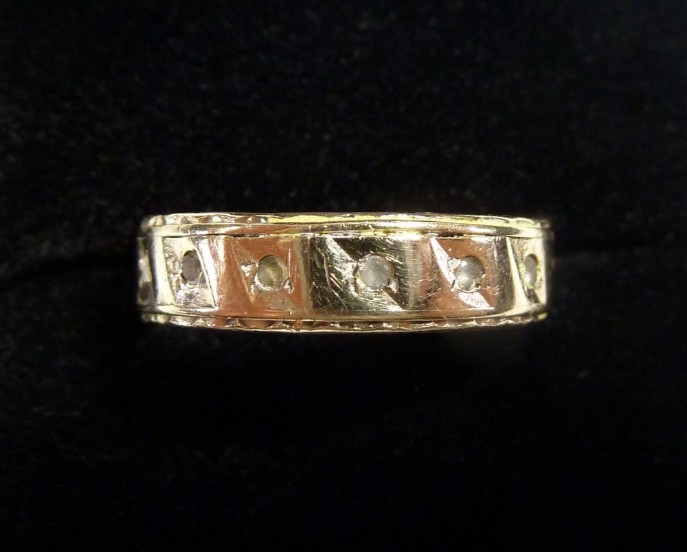 A 9 carat gold eternity ring set white stones - some deficient, 2.5g, size M