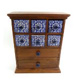 A small spice cabinet with six blue and white china drawers, 30cm tall