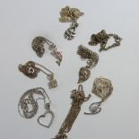 Eight various silver pendants and chains