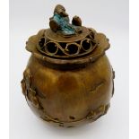 A Japanese brass incense burner with cast rat finial to lid and decoration to body raised on three