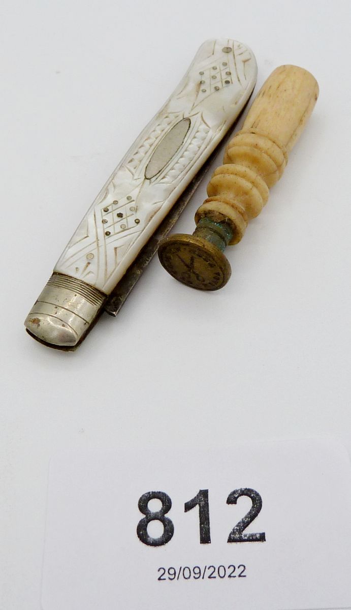 A silver and mother of pearl folding fruit knife and a bone seal embossed with pair of scissors