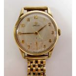 An Omega 9 carat gold gentleman's wrist watch on 9 carat gold strap, with original box, case and