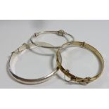 Two silver hinged bangles and a rolled gold one
