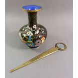 A Chinese brass paperknife with integral magnifying glass and an enamel vase