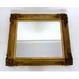A 19th century carved and gilt mirror with shell and foliate corners, 87 x 98 cm