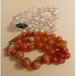 A graduated cornelian bead necklace, 50cm and a crystal necklace with jet and paste clasp