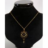An Edwardian gold openwork pendent set seed pearls and garnets, 1.5gm on yellow metal chain, boxed