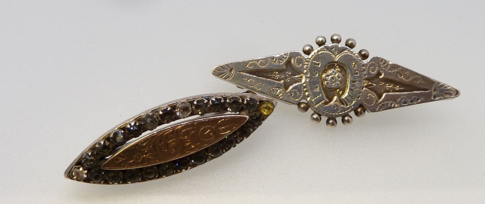 A Victorian silver brooch with paste surround and yellow metal engraved centre plus a silver