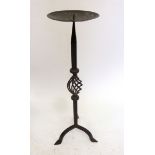 A wrought iron floor standing candlestick on triple base, 66 cm high