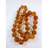 A large 'amber' graduated bead necklace with screw barrel clasp, measures approx. 80cm long
