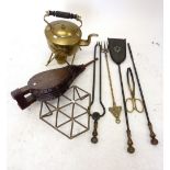 An Edwardian brass spirit kettle on stand and various fire side items including bellows and fireside