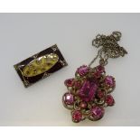 A pink paste locket pendant and an enamelled brooch by Catherine Popesco