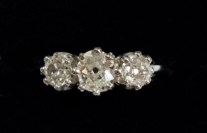 A platinum three stone diamond ring, size P to O, total diamond weight 1.32 carats