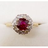 An 18 carat gold ruby and diamond cluster ring, size N
