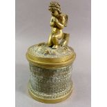 A 19th century brass inkwell with cherub to lid, 14cm