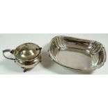 A silver oval dish, Sheffield 1910 and a silver mustard pot with liner, Birmingham 1923, total