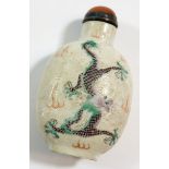 A Chinese late Qing porcelain snuff bottle painted dragons amongst the waves with agate set lid