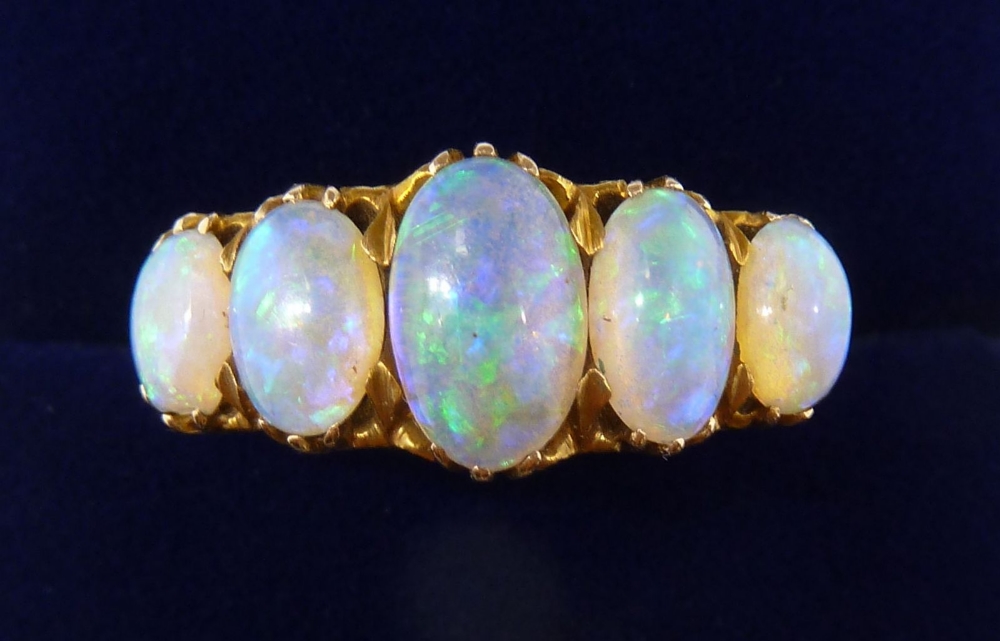 An 18 carat gold five stone opal ring, size O, 5.2g, unmarked