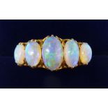 An 18 carat gold five stone opal ring, size O, 5.2g, unmarked