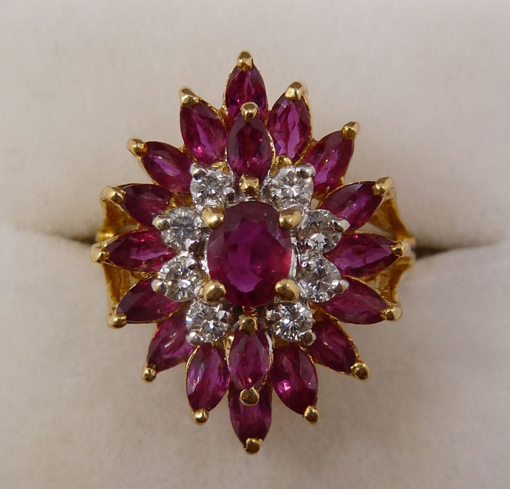 An 18 carat gold three tier ruby and diamond cluster ring, size K-L, 5.6g