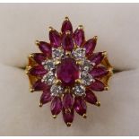 An 18 carat gold three tier ruby and diamond cluster ring, size K-L, 5.6g