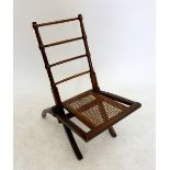 A 19th century small mahogany folding campaign chair with spindle back and cane seat