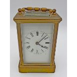 A brass carriage clock with key, 11.5cm