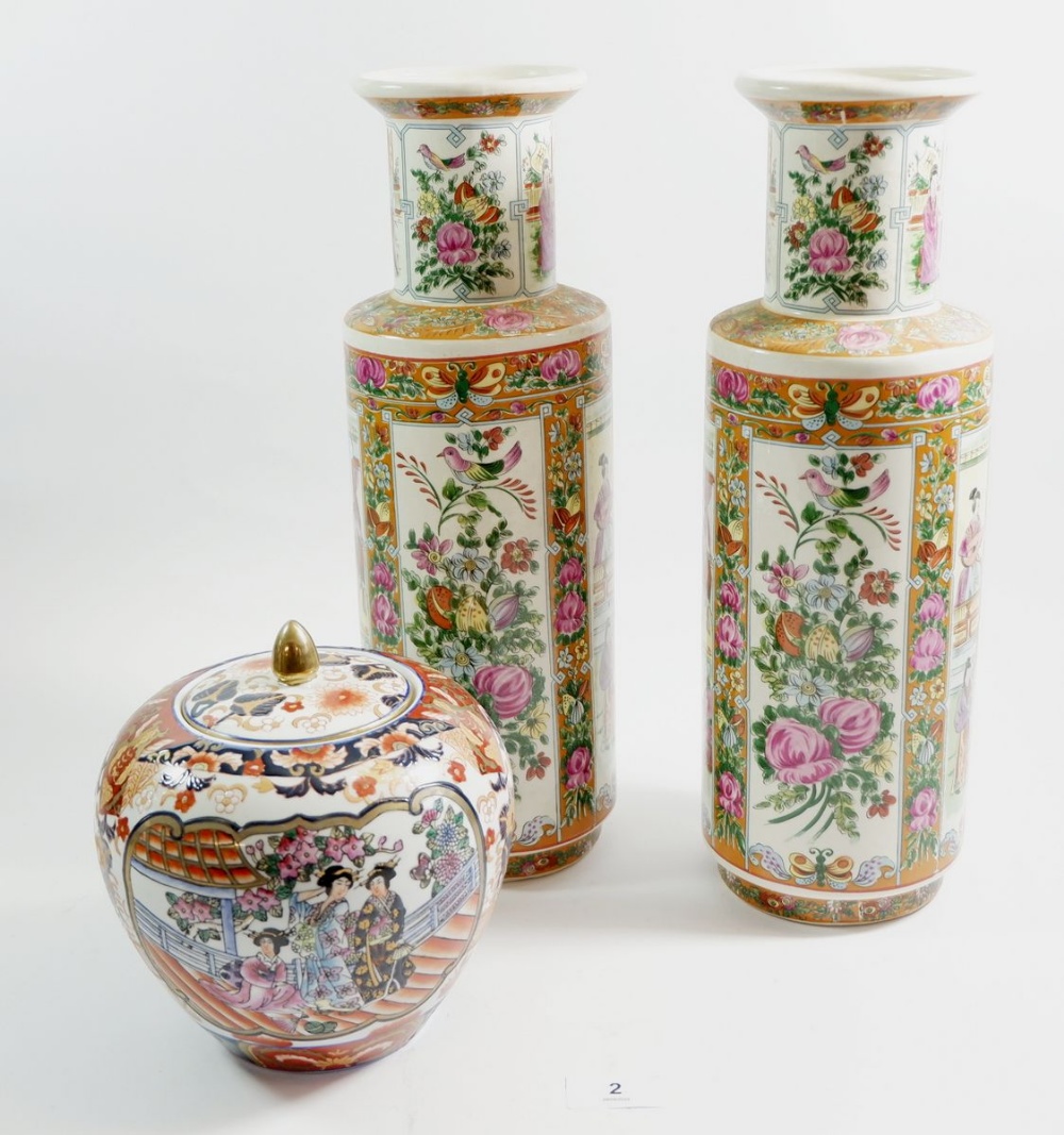 Two Chinese vases decorated figures, 37 cm high, and a Hong Kong Imari jar with lid