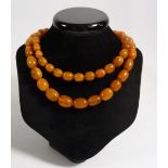 A yellow amber bead necklace, 49g