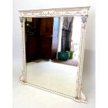 A large Victorian white painted overmantel mirror with moulded and painted neo-classical