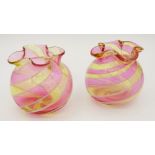 A pair of small pink and yellow glass frill top spiral blown vases, 4.5 cm tall