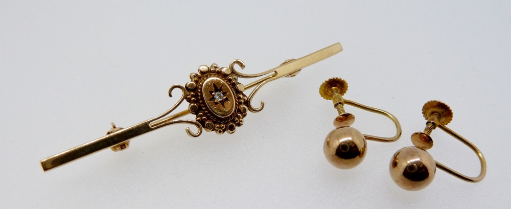 A Victorian gold bar brooch with oval plaque, set chip diamond, 2.2g, 5.3 cm (unmarked) and a pair
