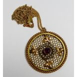 An Edwardian gold plated pendant inset seed pearls and purple stone