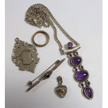 A silver and amethyst pendant, silver heart form pendant, eternity ring and a silver sports medal