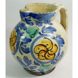 An antique Majolica jug with blue and yellow decoration, 23cm tall