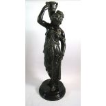 A painted spelter figure of a water carrier, 56cm tall