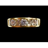 An 18 cart gold ring set three brilliant cut diamonds and four baguette cut diamonds, size N,